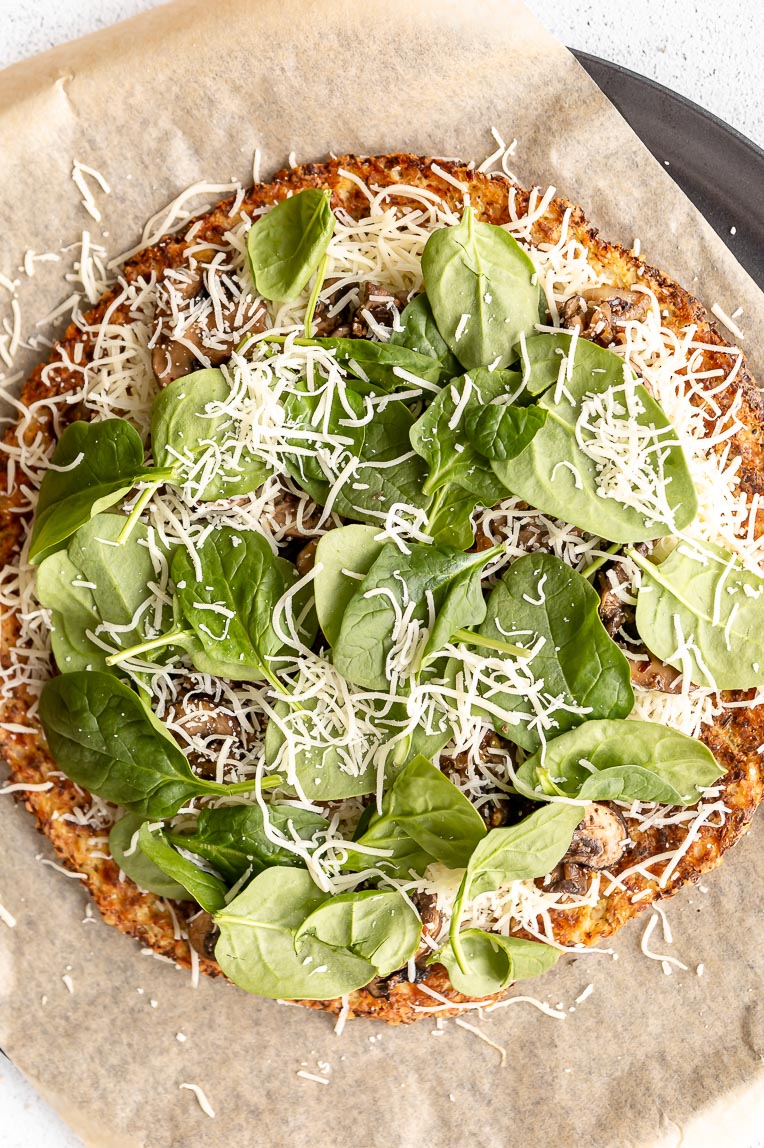 Pizza toppings on a mushroom cauliflower pizza.