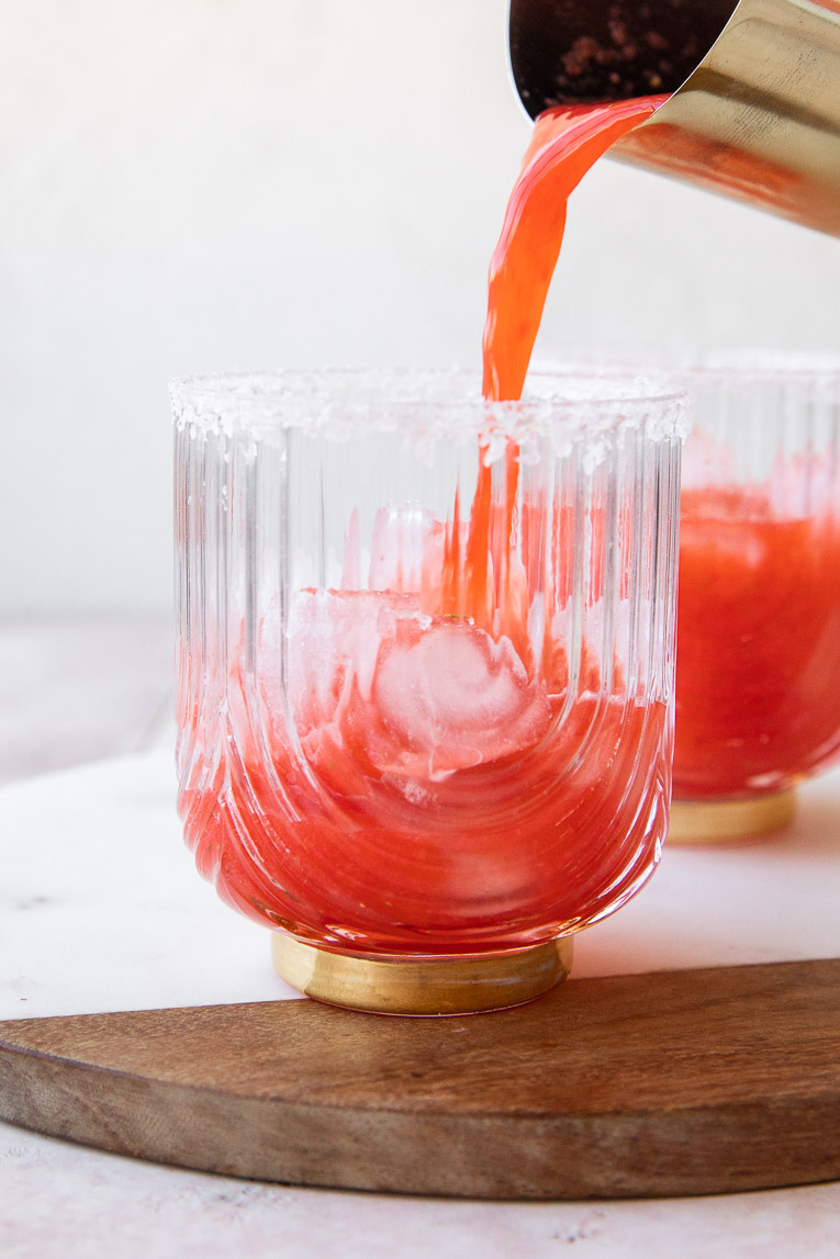 Strawberry Lime Mocktail being poured into a glass.