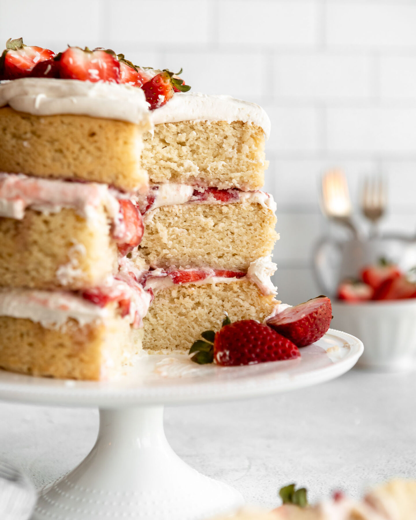 3-layer Vegan Strawberry Shortcake recipe on a cake stand.