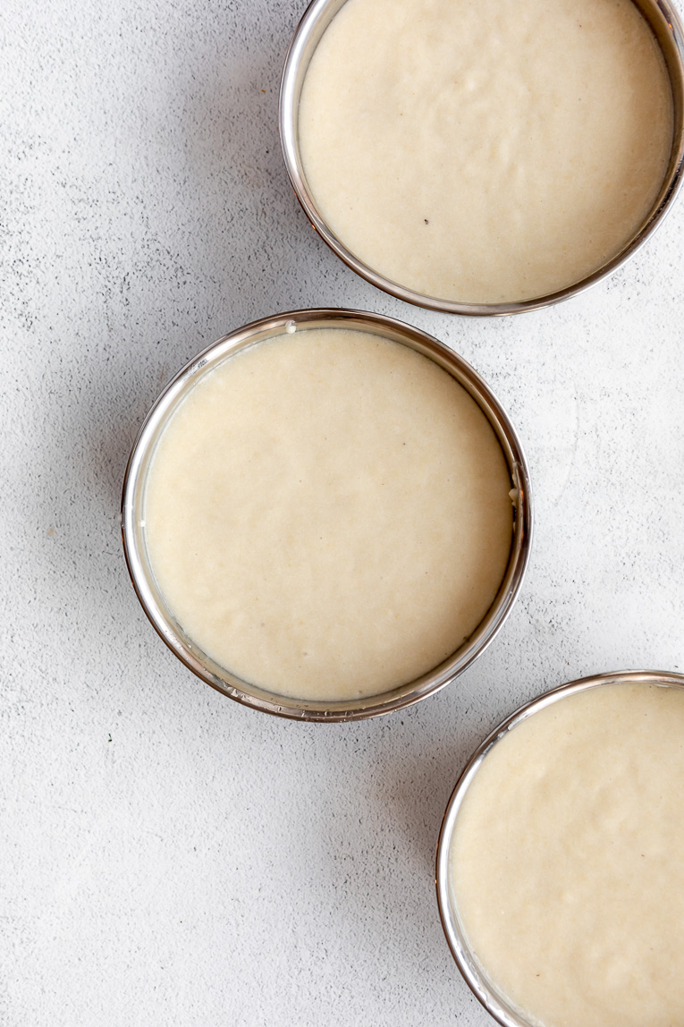 Vegan cake batter in 3 cake pans.