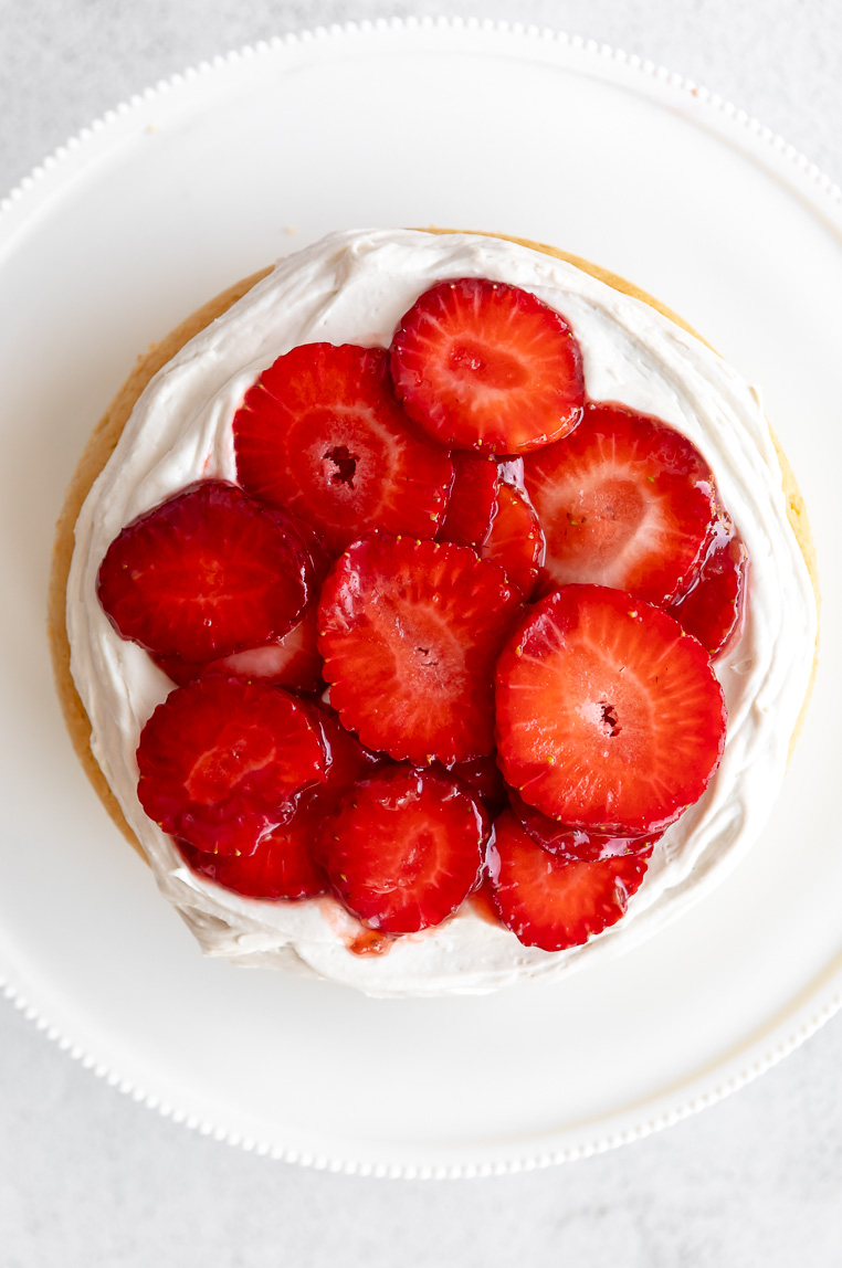 Vegan shortcake with frosting and strawberries on top.