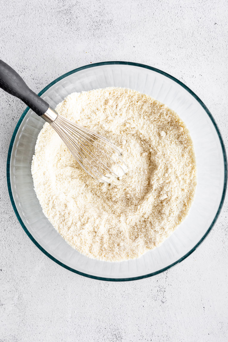 Dry ingredients being stirred together in a bowl.
