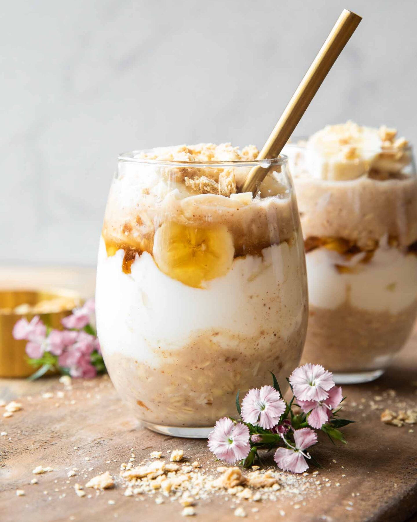 Banana Coconut Cream Pie Overnight Oats recipe on a wood board.
