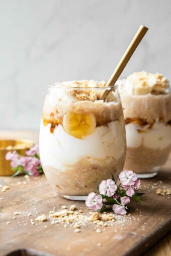 Banana Coconut Cream Pie Overnight Oats recipe on a wood board.