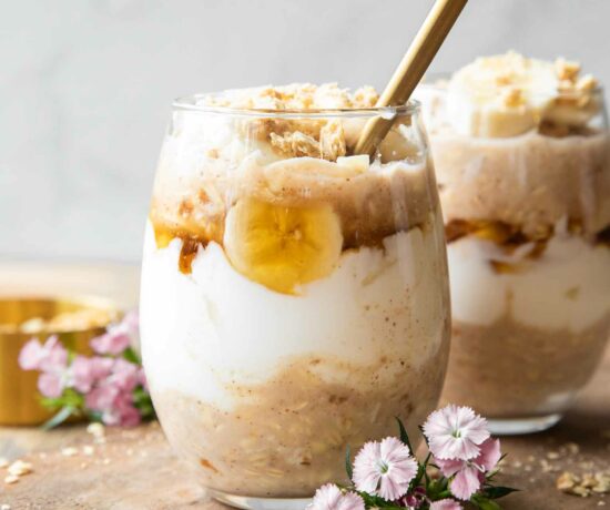 Banana Coconut Cream Pie Overnight Oats recipe on a wood board.