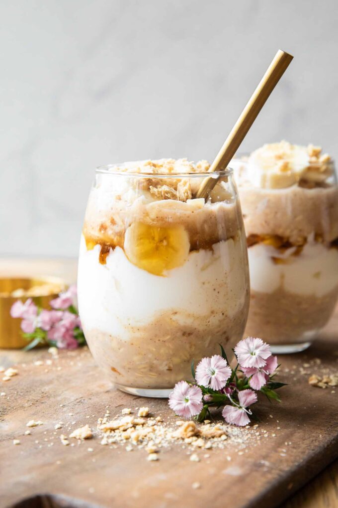 Banana Coconut Cream Pie Overnight Oats recipe on a wood board.