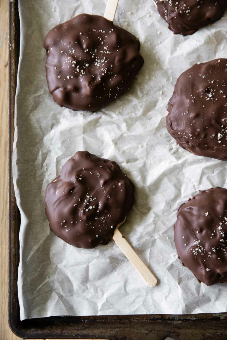 Healthy Buster Bars frozen on parchment paper.