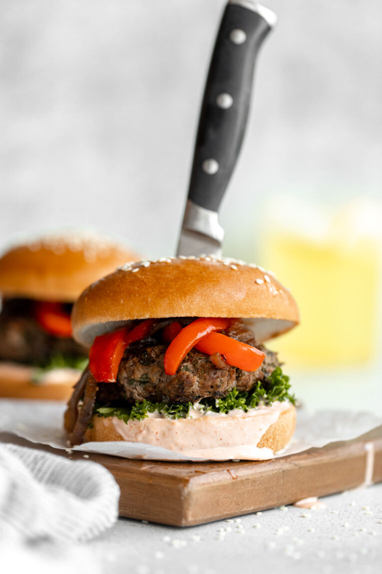 Kale beef burgers on a cutting board.
