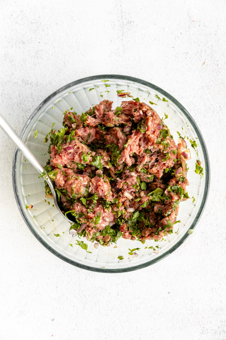 Kale beef burger mixture in bowl.