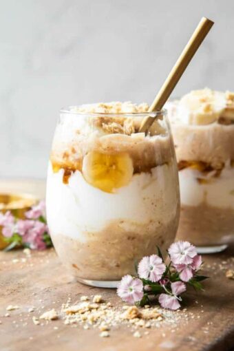 Banana Coconut Cream Pie Overnight Oats recipe on a wood board.
