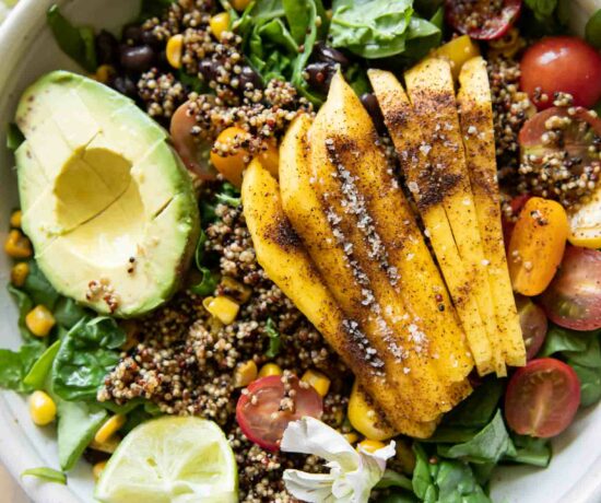 Chili Mango Zesty Quinoa Salad with fork and lime.