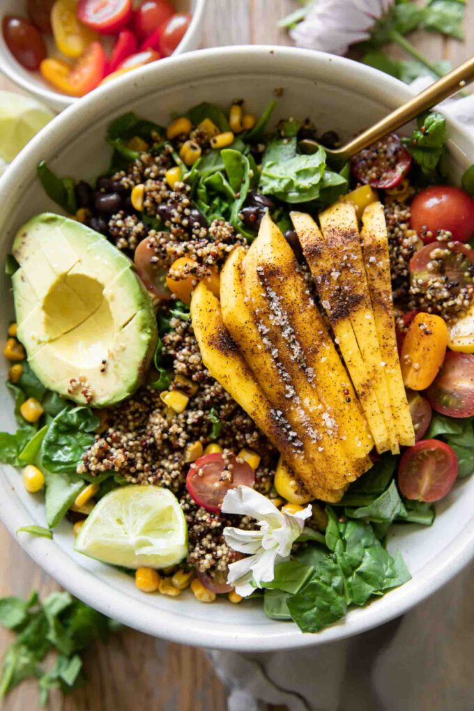 Chili Mango Zesty Quinoa Salad with fork and lime.