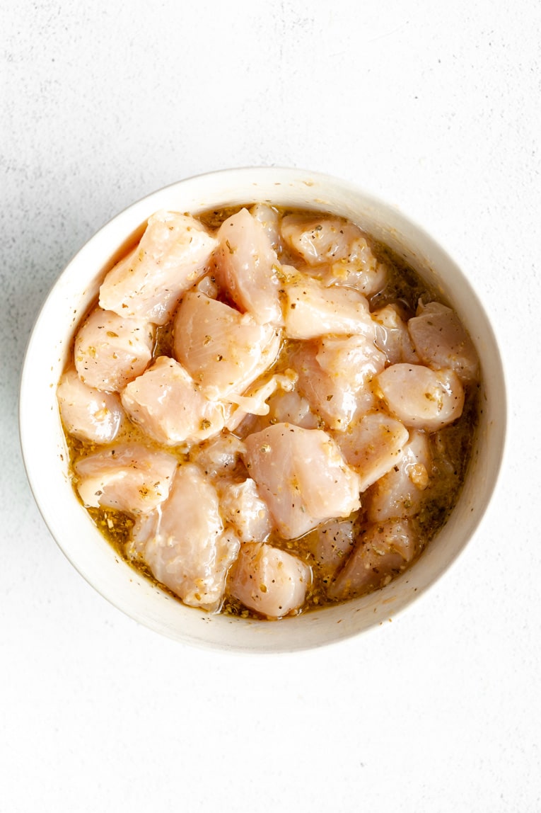 Greek chicken cubed in a dish.