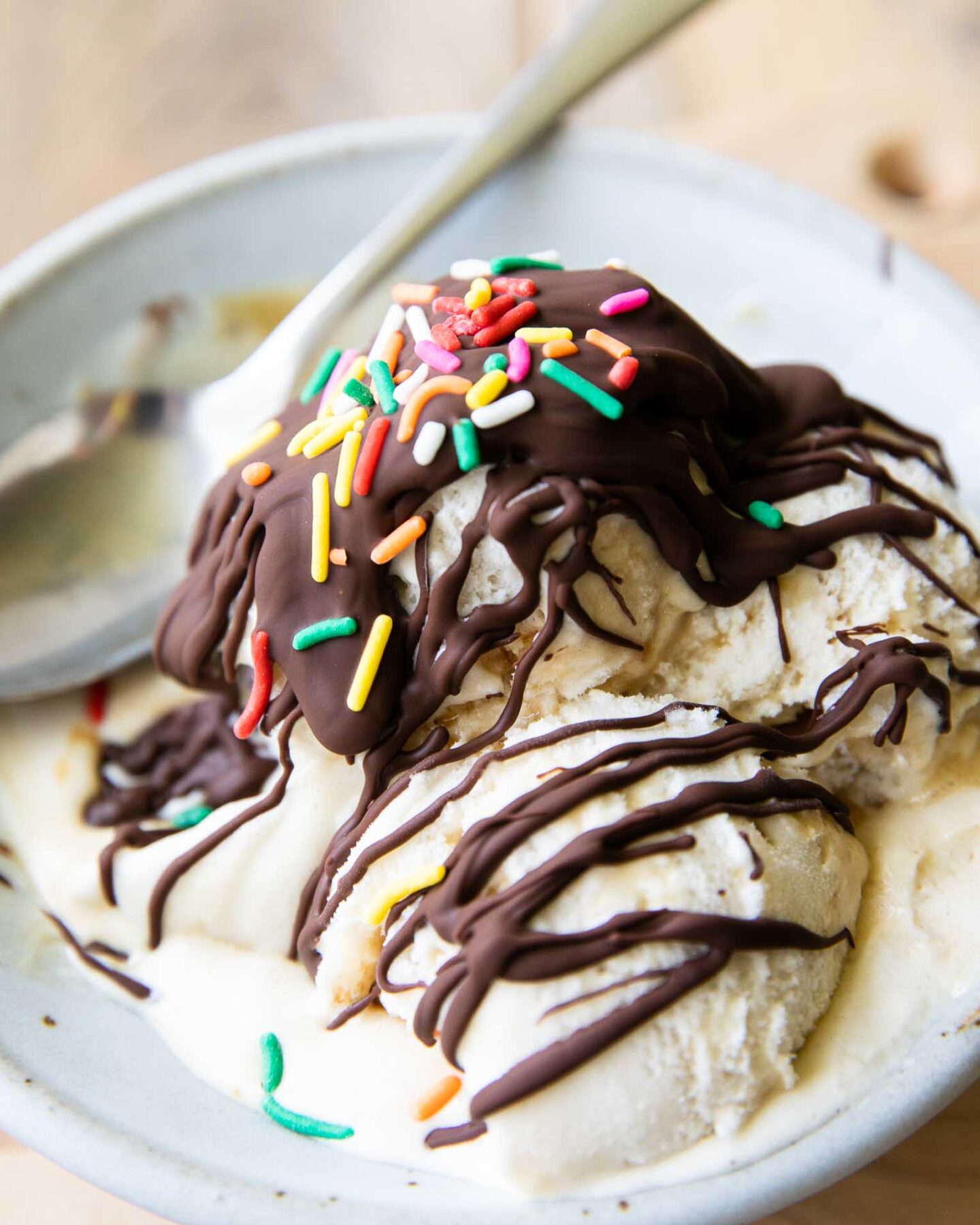 Homemade magic shell recipe drizzled over ice cream scoops.