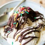 Homemade magic shell recipe drizzled over ice cream scoops.