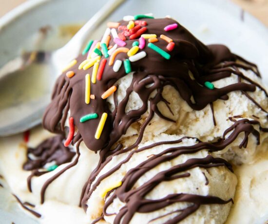 Homemade magic shell recipe drizzled over ice cream scoops.