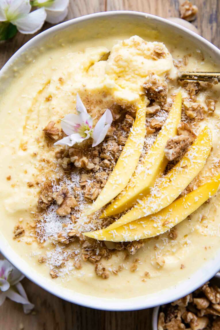 Close up of Mango Pineapple Smoothie bowl with coconut and granola.