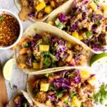 Vegan Spicy Thai Tofu Tacos on a wood table.