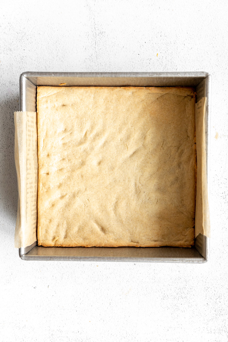 Healthy cheesecake bar crust in a pan.