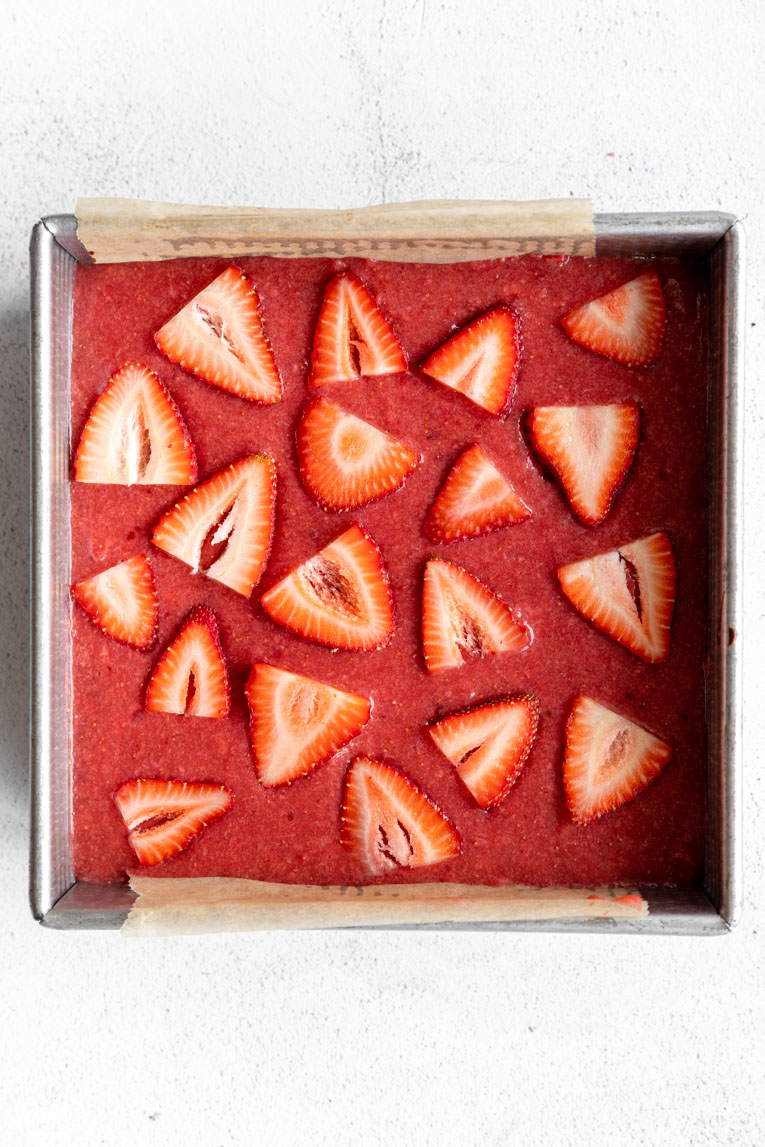 Strawberry cheesecake topping over bars.