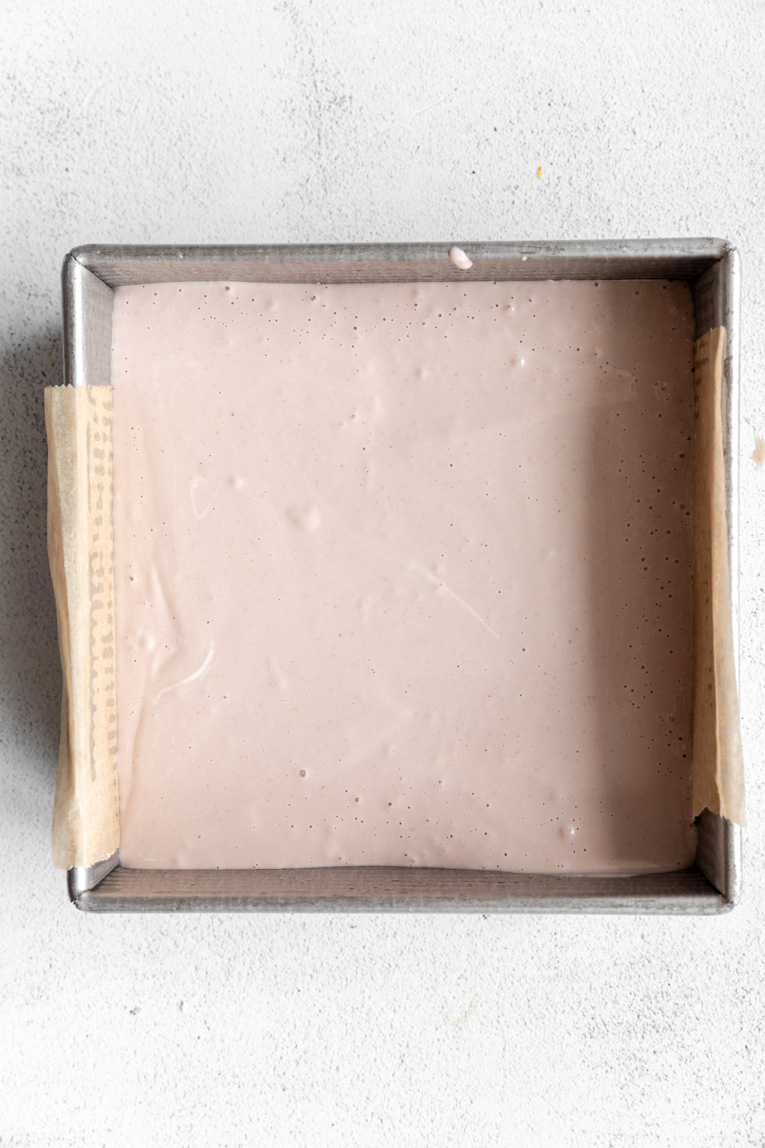Strawberry cheesecake filling in a pan for bars.