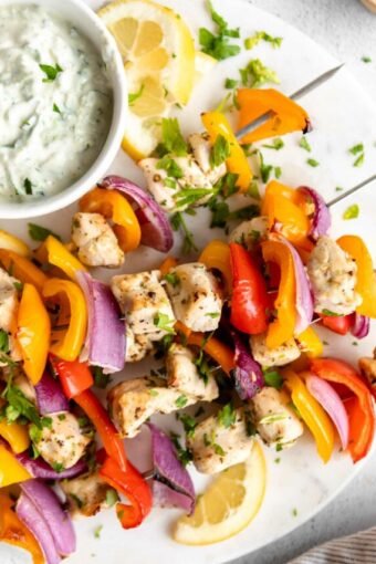 Close up of Greek Chicken Kabobs with Tzatziki sauce.