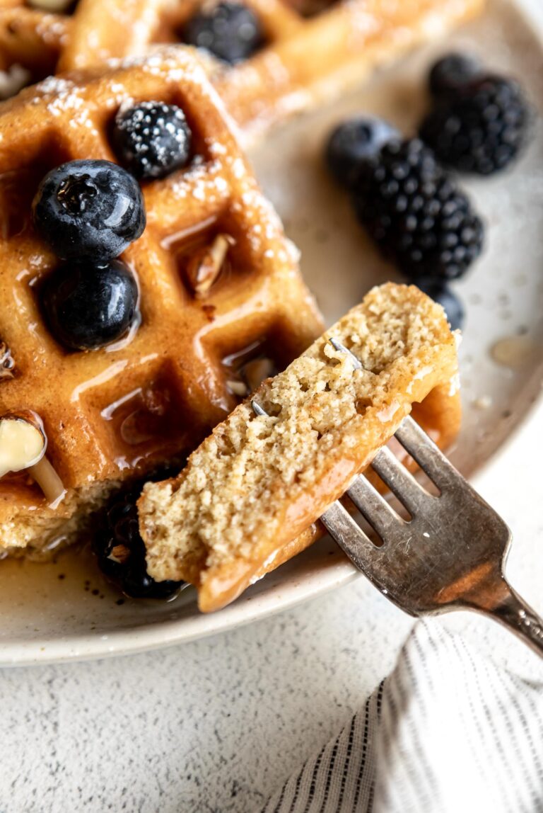Light and fluffy bite of Almond Flour Waffle with a fork.