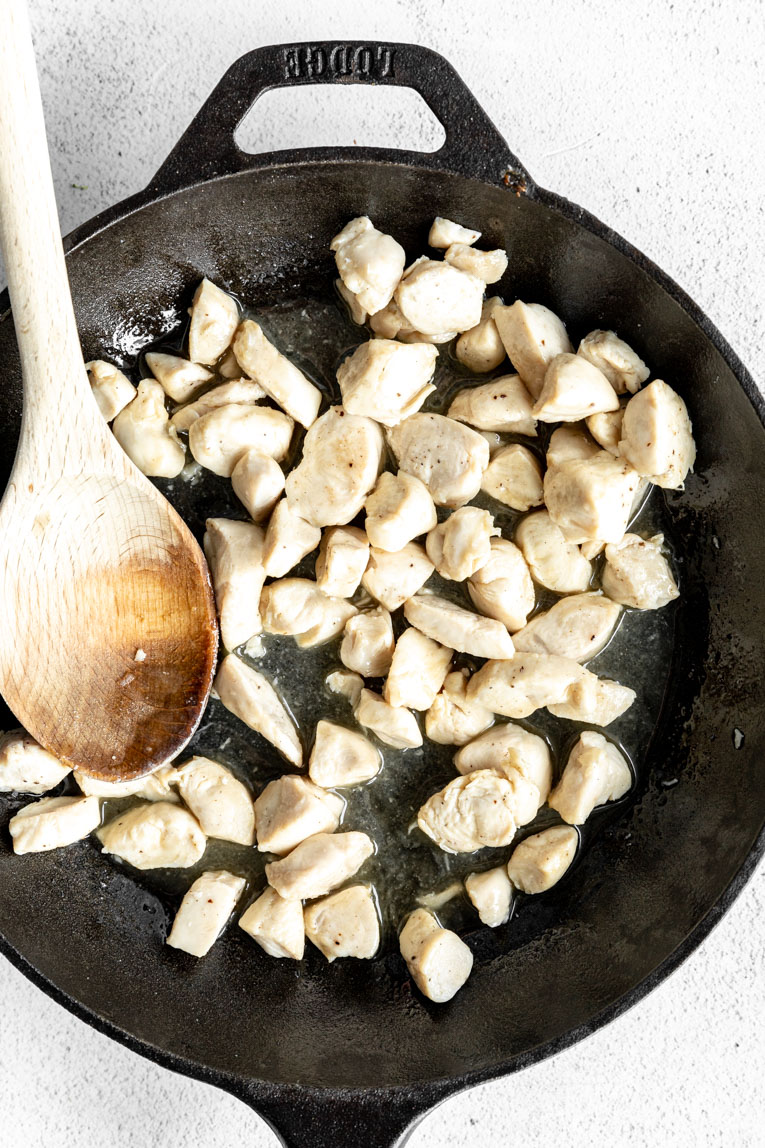 Chicken being cooked in a skillet.