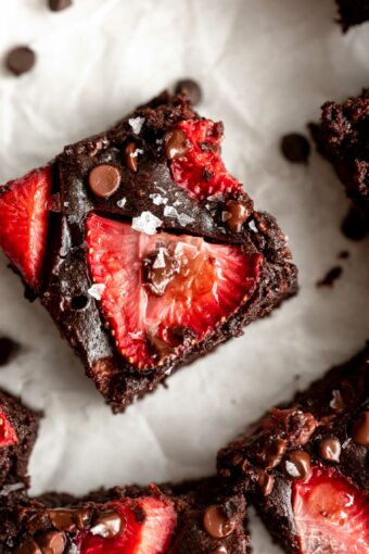 Top photo of chocolate brownie with strawberry slices.