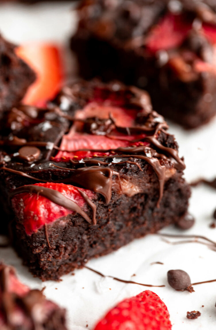 Close up of chocolate brownie with strawberries.
