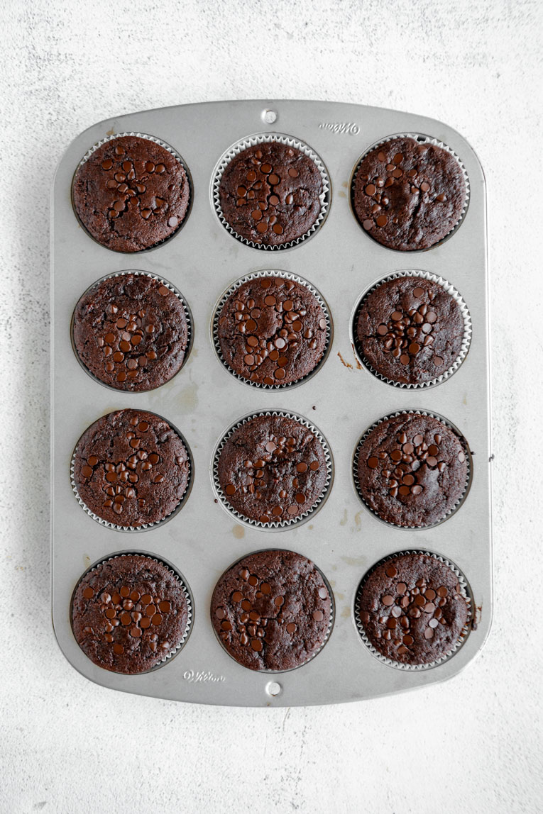 Baked Chocolate zucchini muffins in a tin.