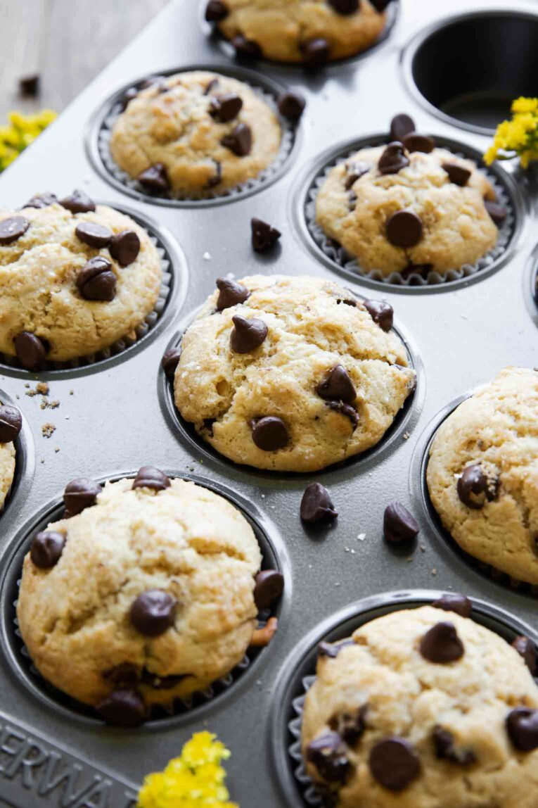 Angled photo of Healthy Chocolate Chip Muffins in a muffin tin.