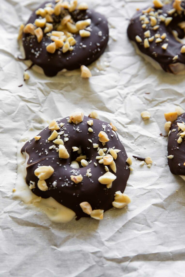 Chocolate covered apples on parchment paper.