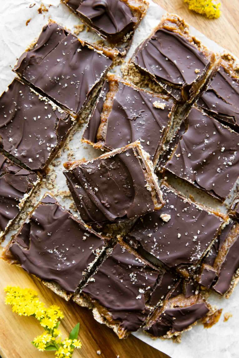 Homemade Date Twix Bars on parchment paper.