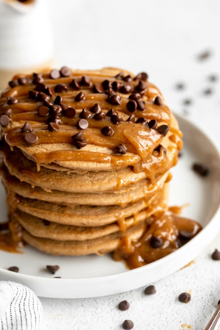 Mocha Protein Peanut Butter Pancakes recipe with peanut butter drizzle and chocolate chips.