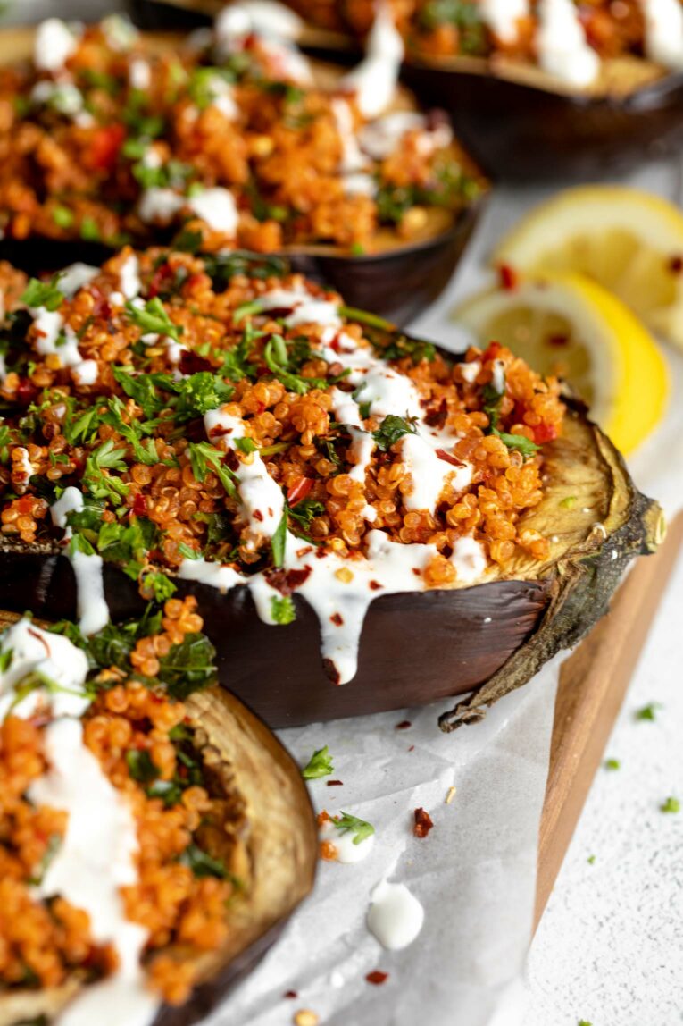 Angled photo of Roasted Harissa Stuffed Eggplant halves.