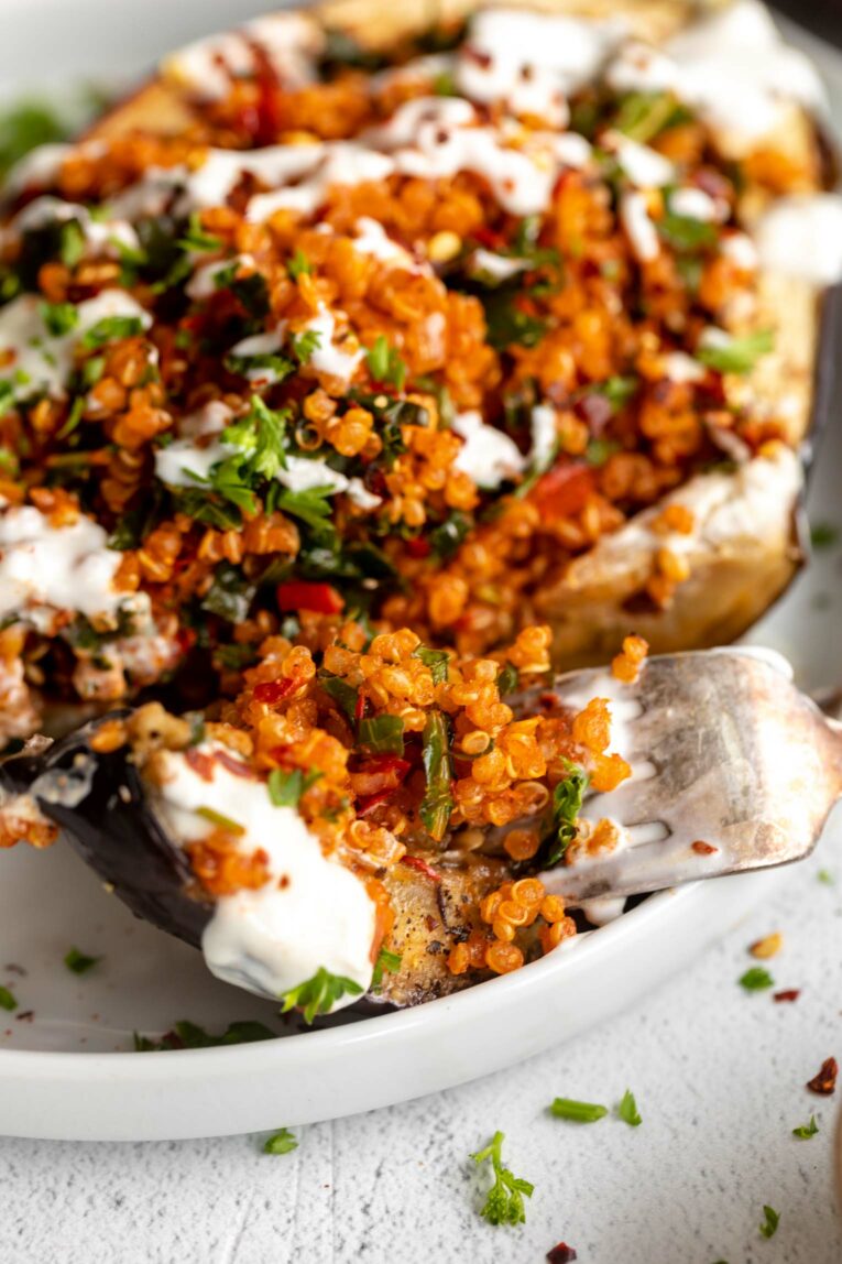 Roasted eggplant with harissa filling and yogurt sauce.