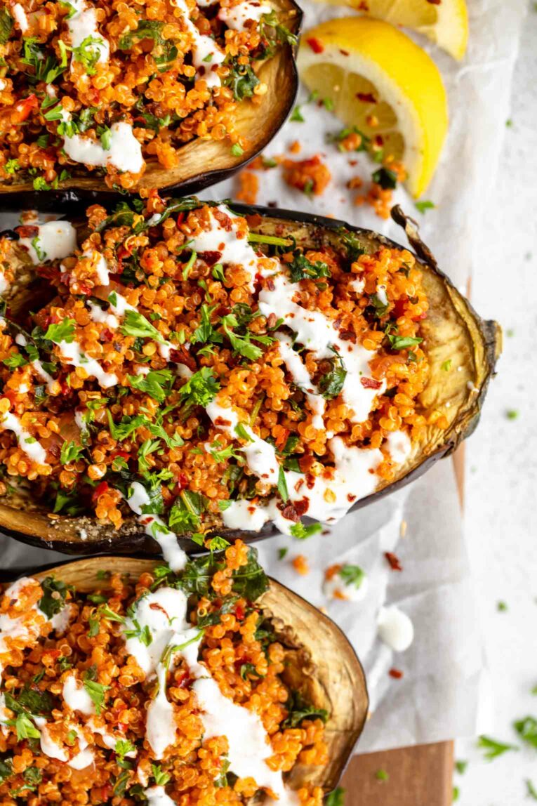 Roasted Harissa Stuffed Eggplant halves on a baking sheet.