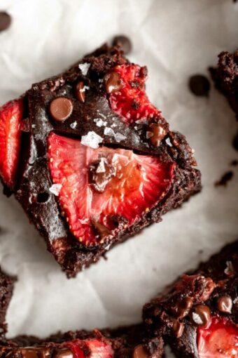 Top photo of chocolate brownie with strawberry slices.