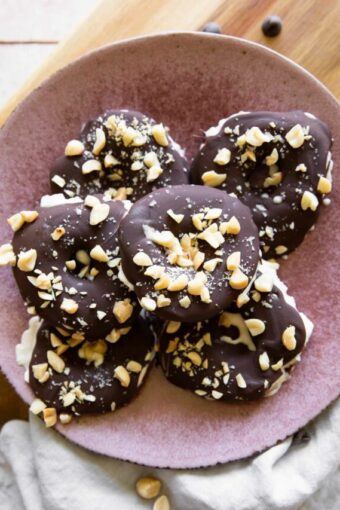 Top shot photo of Chocolate Covered Apples on a pink plate.