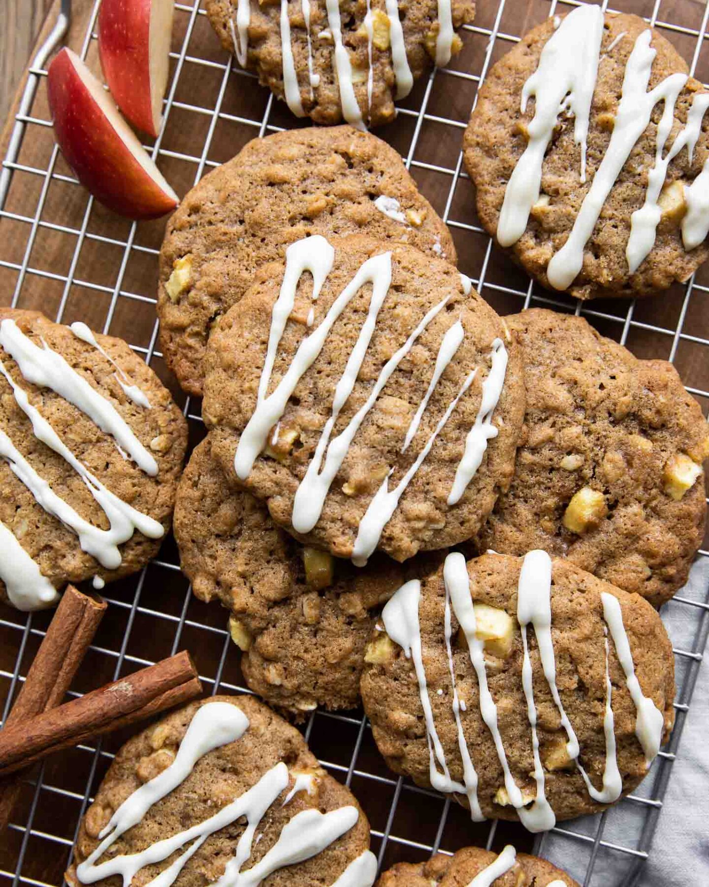 Apple Pie Cookies with white chocolate drizzle on a cookie rack.