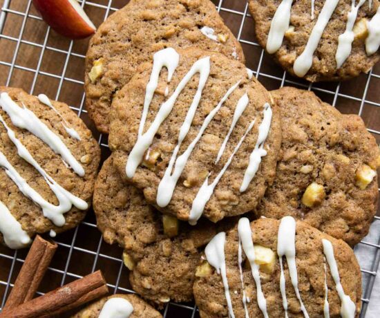Apple Pie Cookies with white chocolate drizzle on a cookie rack.