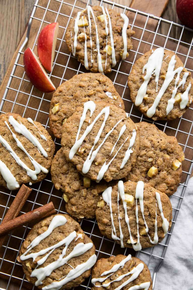 Apple Pie Cookies with fresh apples and oatmeal on a cooling rack.