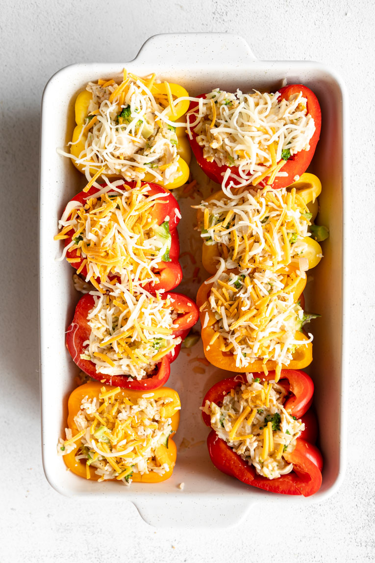 Bell peppers stuffed with chicken and rice filling and topped with cheese.