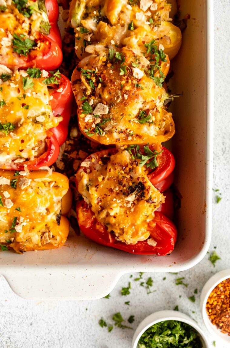 Shredded chicken stuffed peppers in a baking dish.