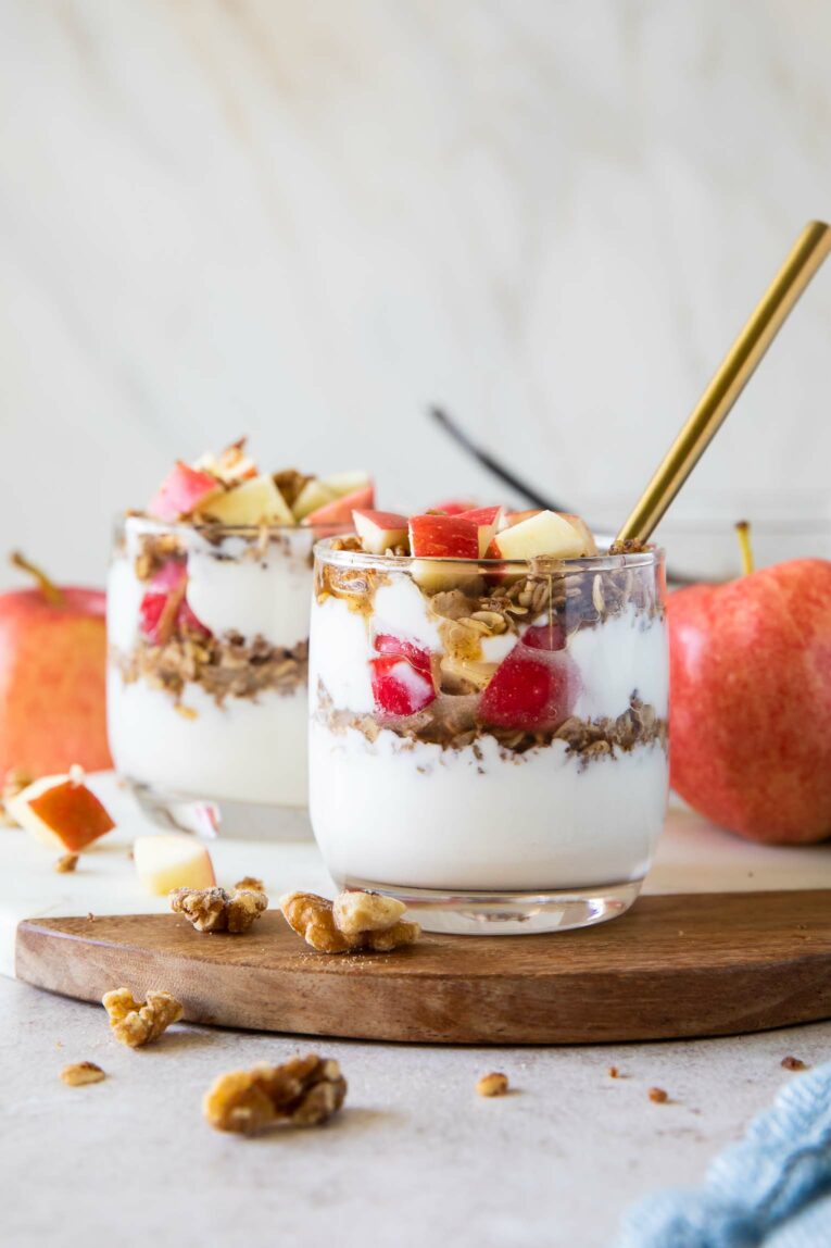 Healthy Apple Crumble Parfaits on a cutting board.