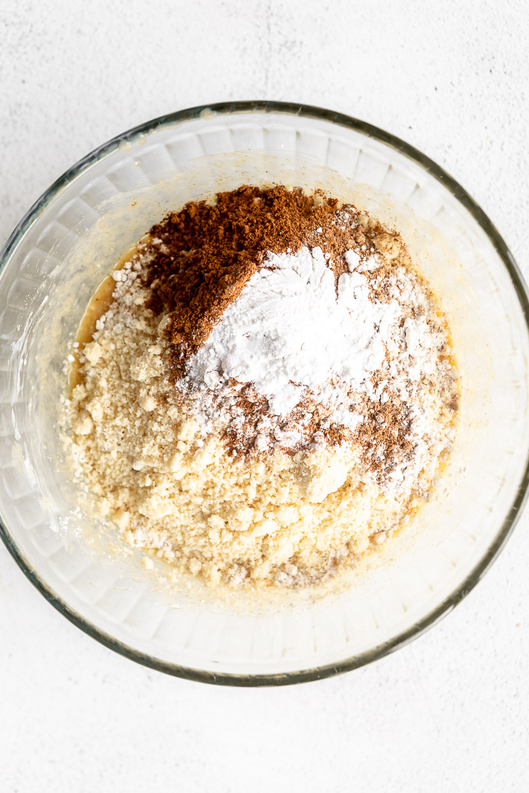 Dry ingredients whisked into liquid ingredients for donuts in a bowl.