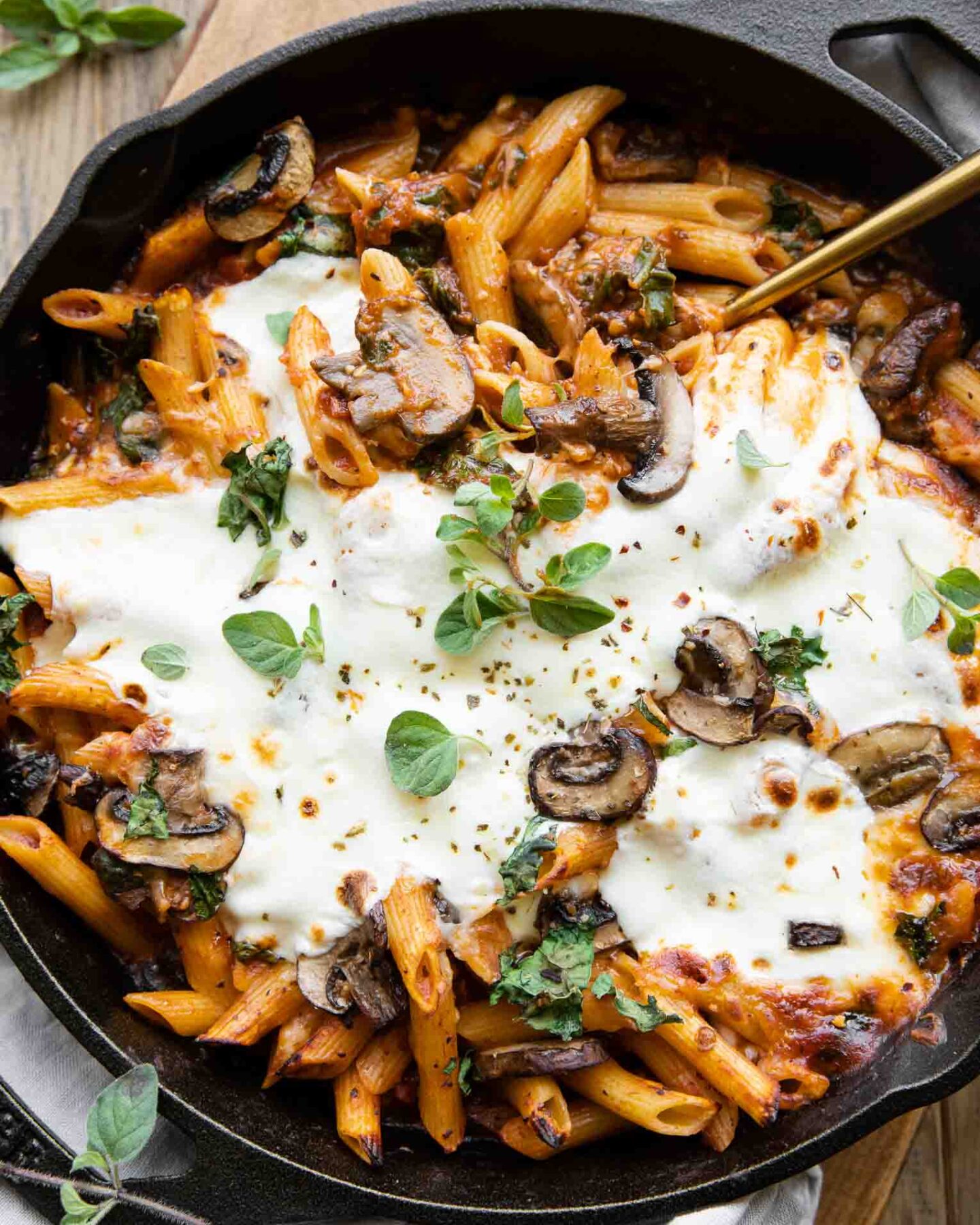 Mushroom & Spinach Pasta Bake recipe with a serving spoon.