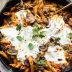 Mushroom & Spinach Pasta Bake recipe with a serving spoon.