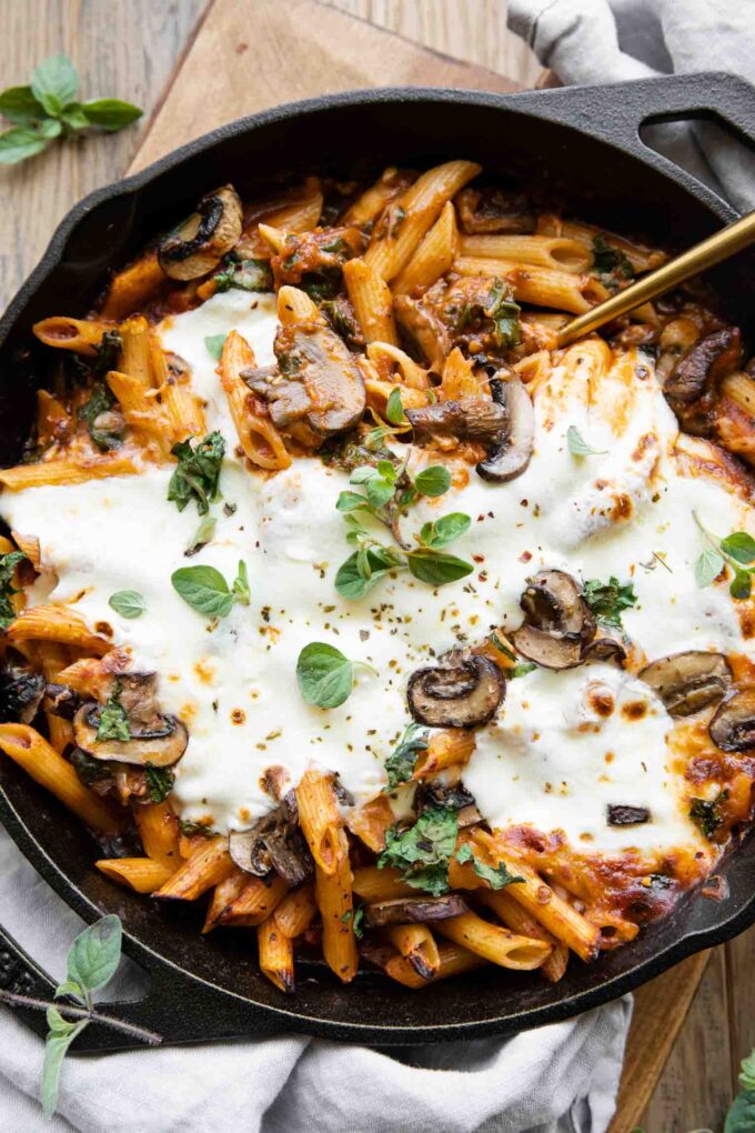 Mushroom & Spinach Pasta Bake recipe with a serving spoon.